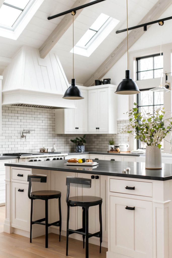 Striking white kitchen cabinets complemented by dark black countertops for a bold contrast.