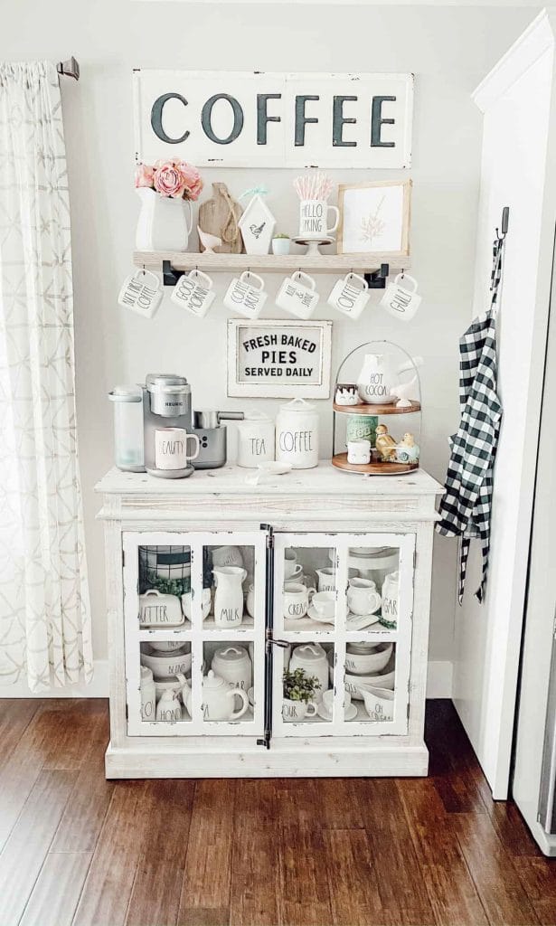 Cozy, cottage-style coffee corner with vintage-inspired decor, open shelves, and small decorative items.