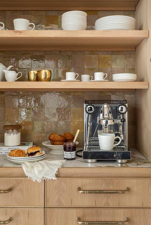 Luxurious coffee setup with stunning marble surfaces, light wood, and sleek appliances.