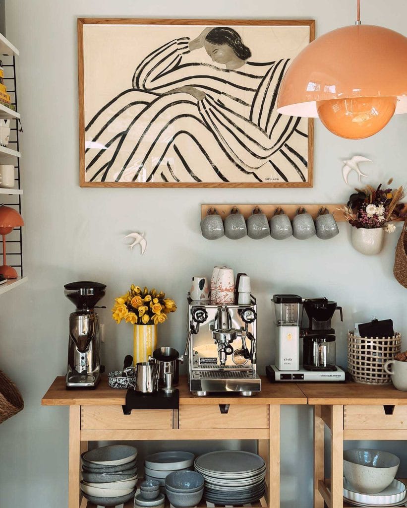 Artistic coffee setup with eclectic decor, vibrant artwork, and colorful canisters.