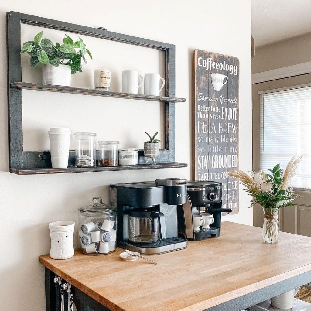 Minimalist coffee setup with open shelves holding mugs, plants, and coffee essentials.