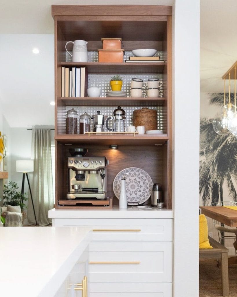 Open-shelf coffee station with wood and metal elements, practical and aesthetically pleasing.