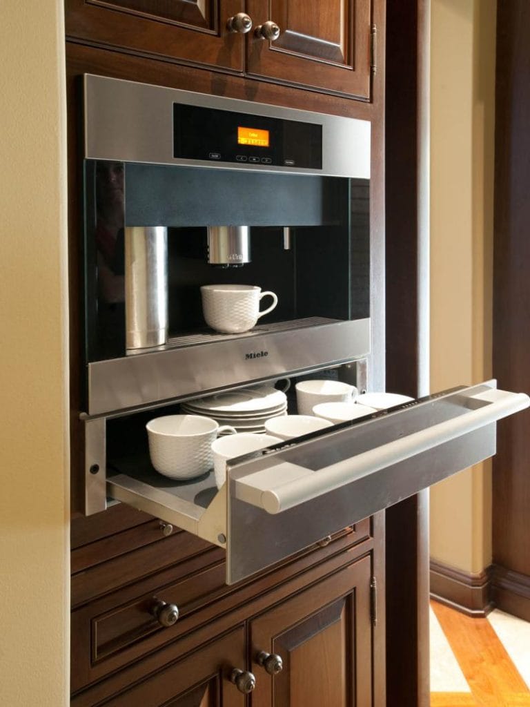 A high-tech coffee station with a built-in espresso machine and sleek stainless-steel accents.