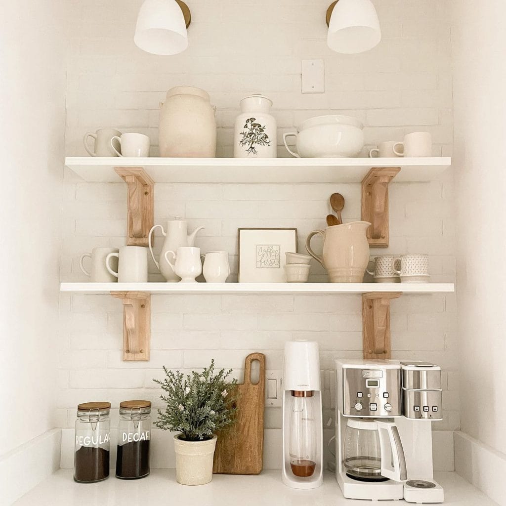 A bright and airy coffee bar with light wood cabinetry, open shelving, and a well-organized display of coffee supplies. The fresh and clean aesthetic is a delightful addition to any kitchen.