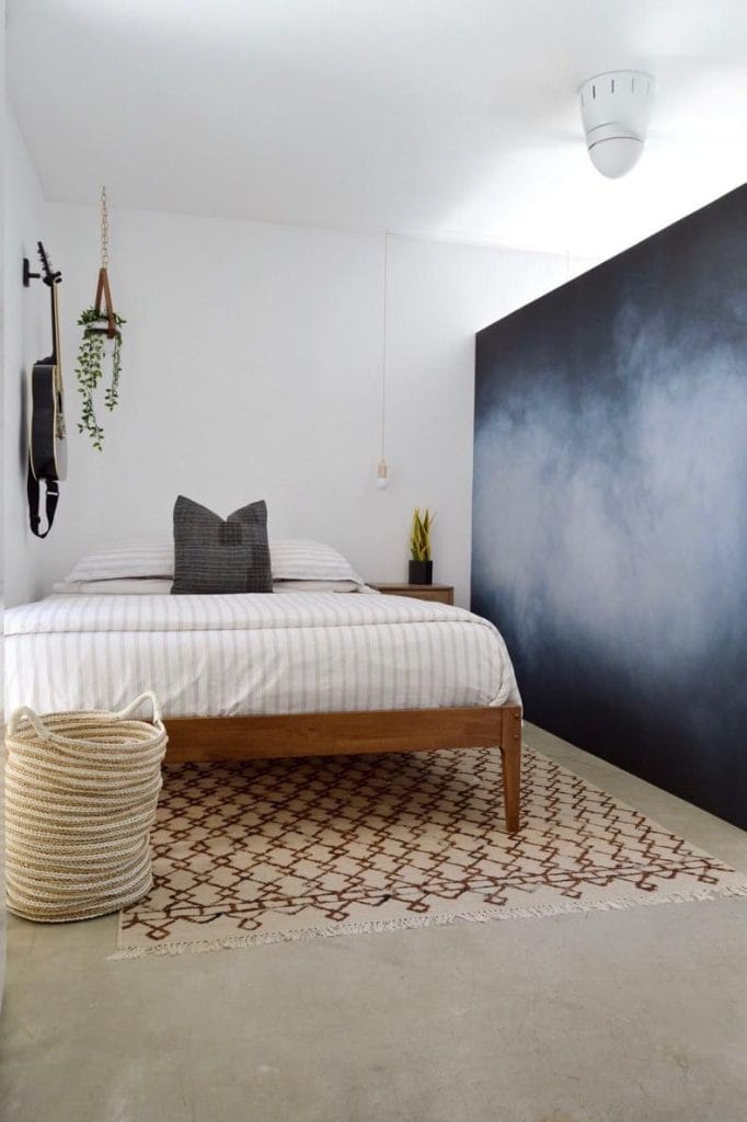 Dorm room with a black and white accent wall.