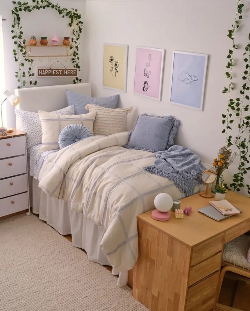 Botanical-themed dorm room with pastel bedding and leafy garlands.