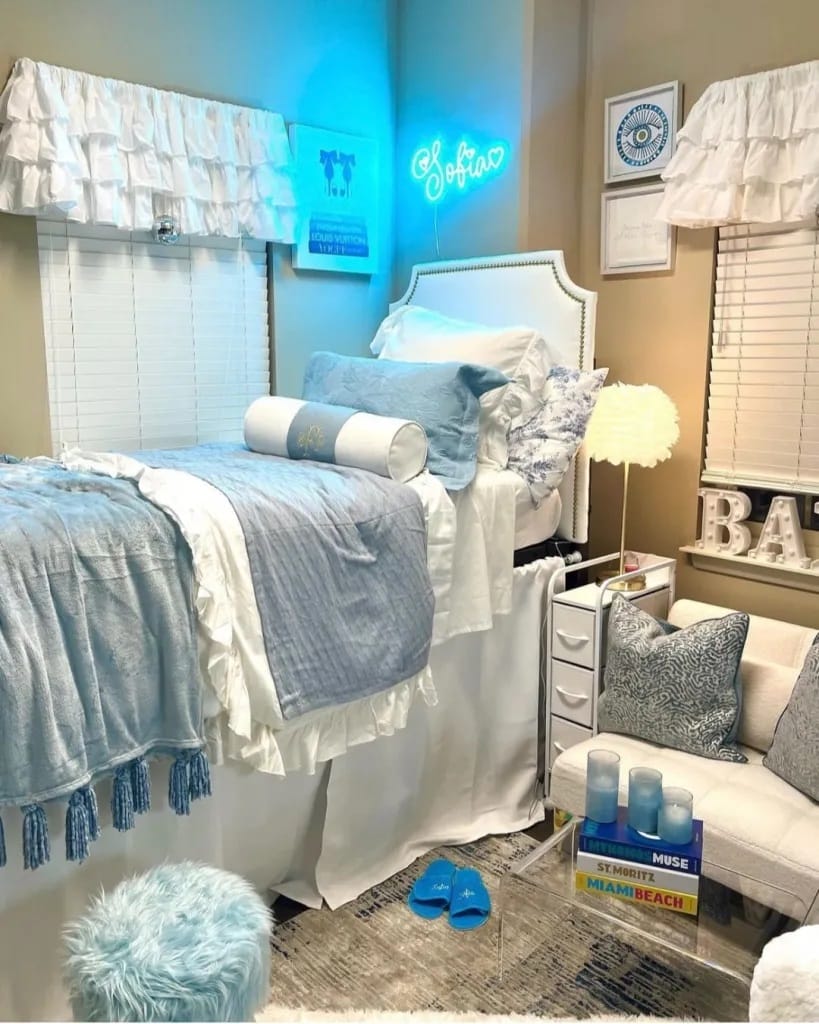 Elegant dorm room with blue and white decor and personalized touches.