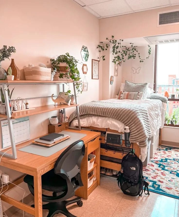 Bedroom with plants, natural light, and cozy bedding.