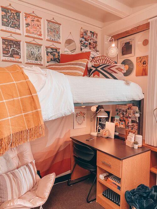 A vintage-style dorm room with vibrant colors, retro wall art, and a lofted bed with a study area underneath.