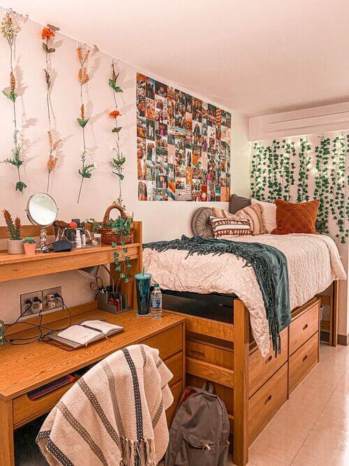 A cozy dorm room with warm lighting, boho decor, and a well-organized desk area.