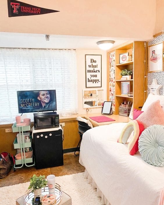 A dorm room with colorful decor, motivational posters, cozy bedding, and plenty of storage creating a vibrant and personalized atmosphere.