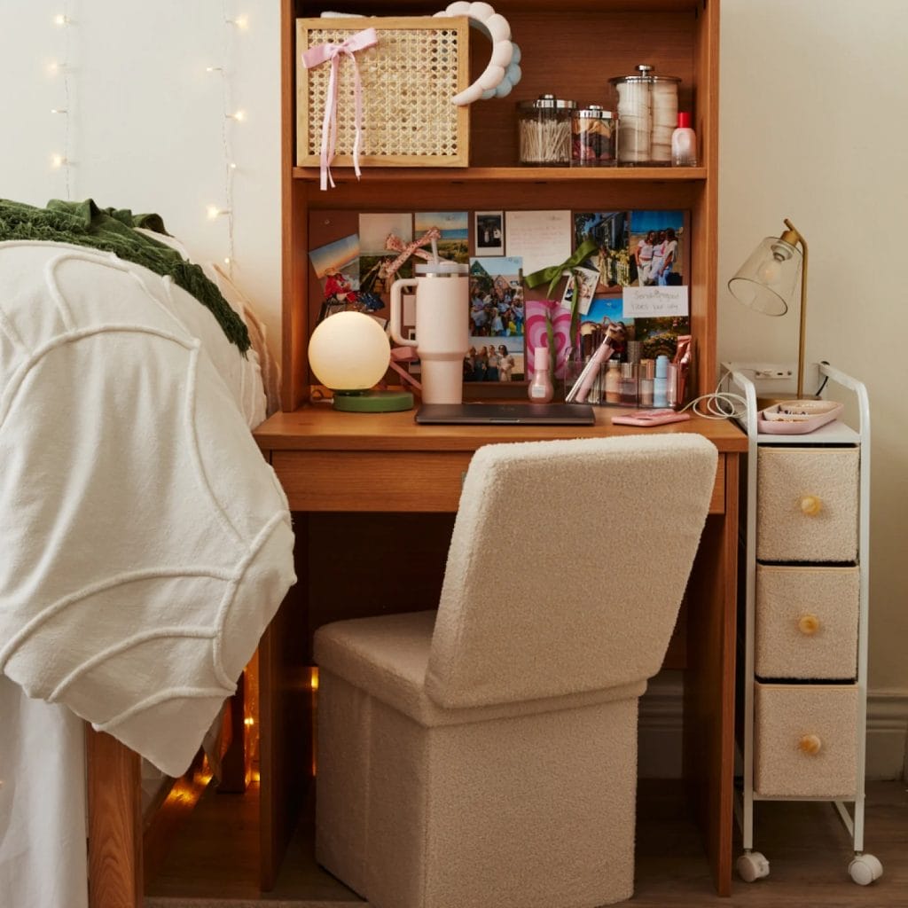 Room with a well-organized study nook, wooden desk, and personal decorations.