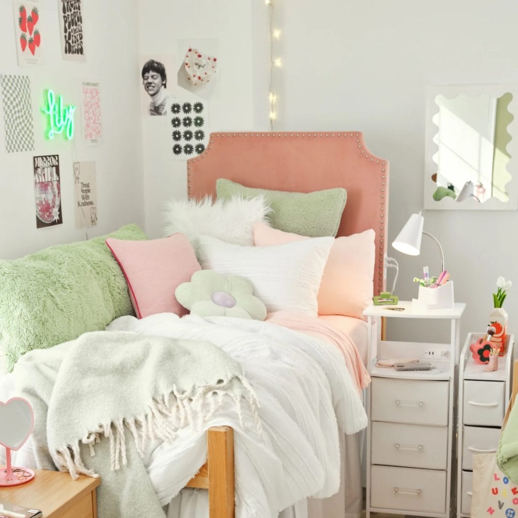 Room with soft greens and pinks, various textures, and inviting decor.