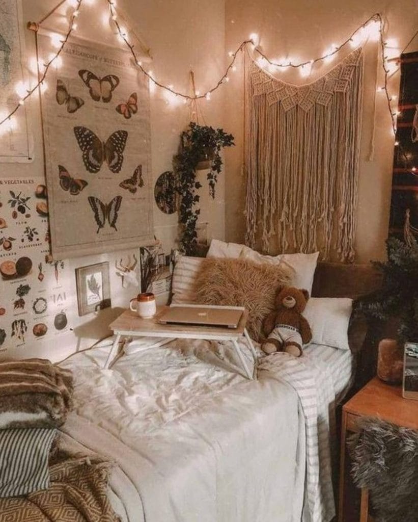 A cozy space with earthy tones, string lights, butterfly wall art, and a macramé wall hanging.