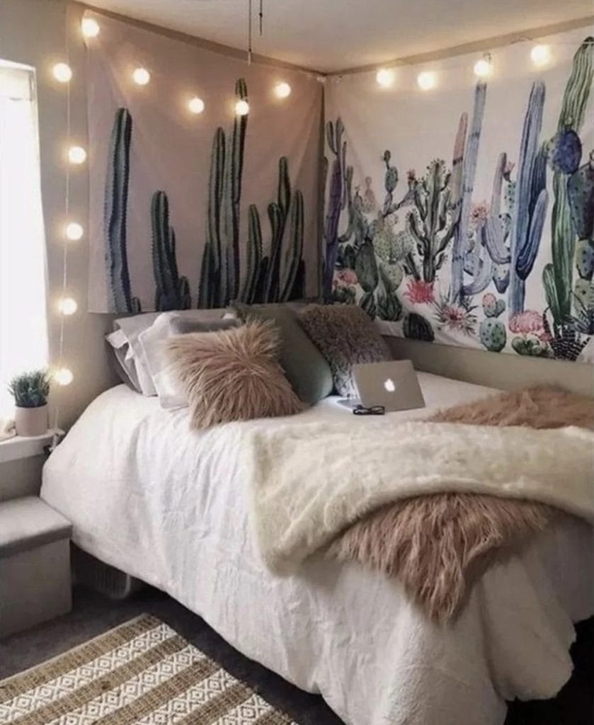 A cozy space with cactus wall art, string lights, fluffy textures, and earthy tones.