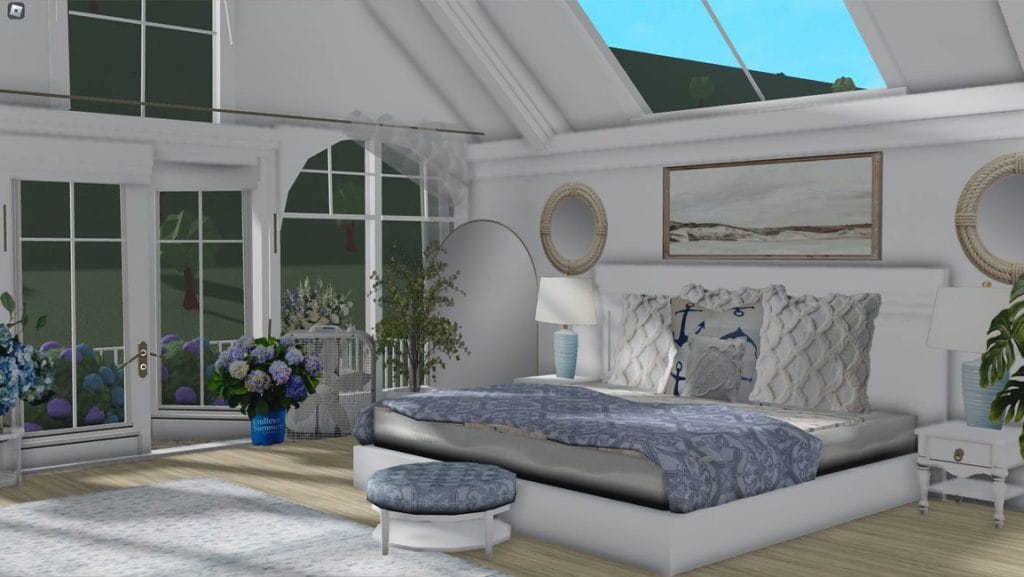 A beach-themed bedroom with blue and white decor, nautical accents, large windows, and light-colored furnishings.