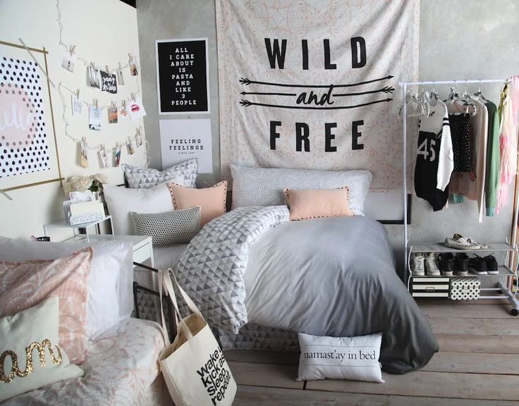 A space with a "Wild and Free" tapestry, patterned pillows, and an open clothing rack.