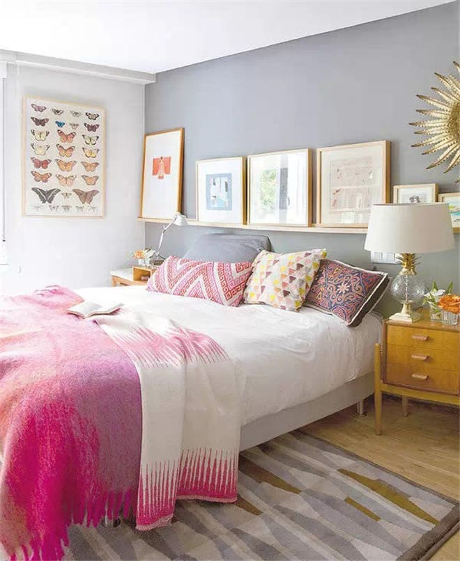 A space with bright pink accents, colorful wall art, and a mix of patterns and textures.