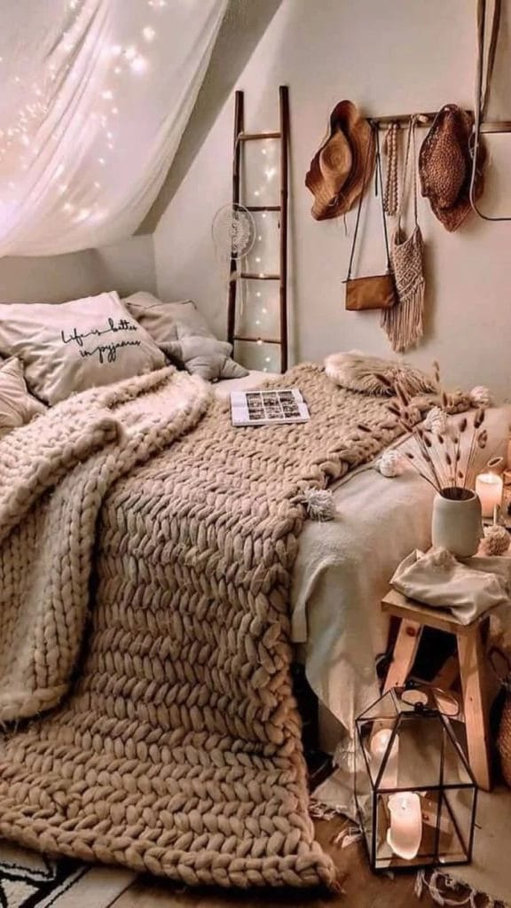 A cozy space with a chunky knit blanket, rustic decor, and soft lighting.