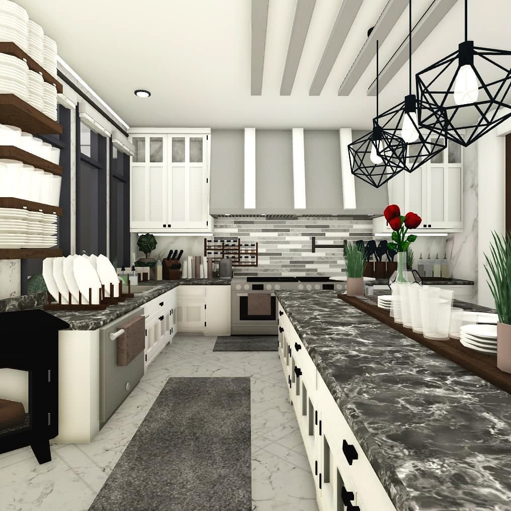 A modern farmhouse-style Bloxburg kitchen with dark marble countertops, open shelving, and industrial lighting.