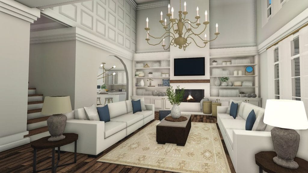 Coastal Bloxburg living room with blue accents, high ceilings, and a grand chandelier.