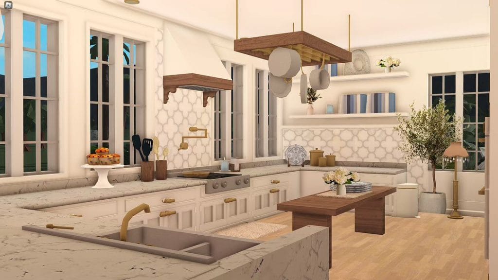 A classic Bloxburg kitchen with white cabinetry, gold hardware, and coastal decor.