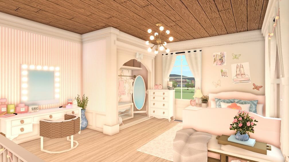 A bright bedroom with light wood ceiling, pink and white decor, a seating area, makeup vanity, and wall art.