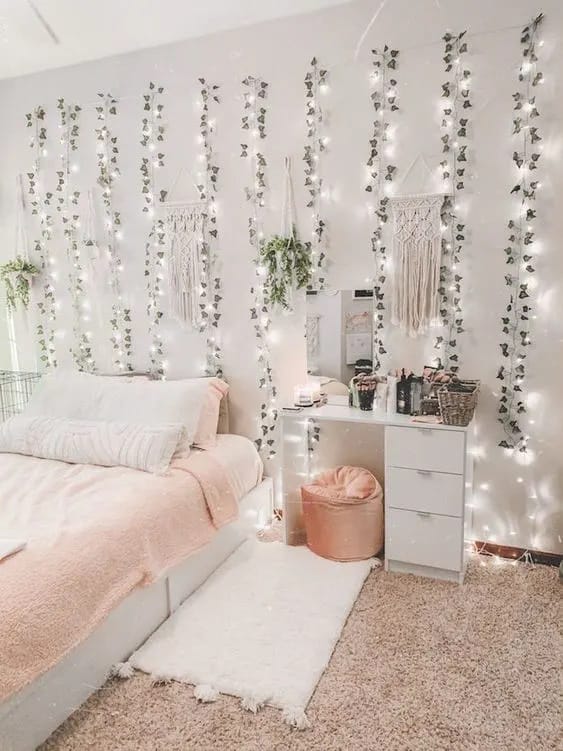 A boho-style bedroom with fairy lights, hanging plants, and soft textures.