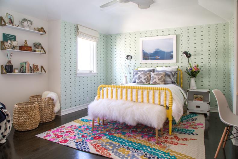 Eclectic boho teen bedroom with a yellow bed frame, vibrant rug, and playful decor.