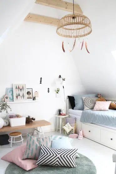 Minimalist attic bedroom with a cozy bed, soft textiles, and a hanging rattan chandelier.