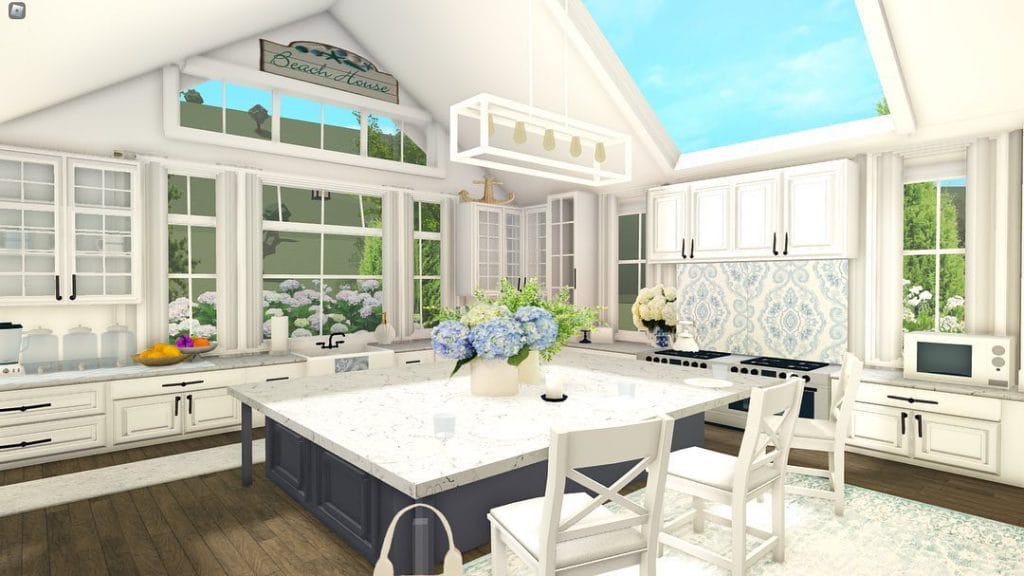 A bright and airy Bloxburg kitchen with large windows, white cabinetry, and a spacious island.