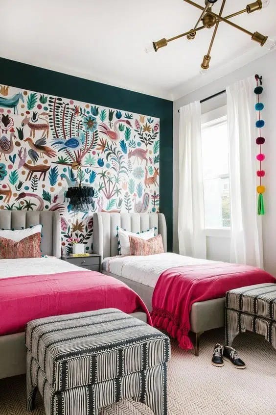 Boho-themed bedroom with two twin beds, colorful wallpaper, and matching stools.