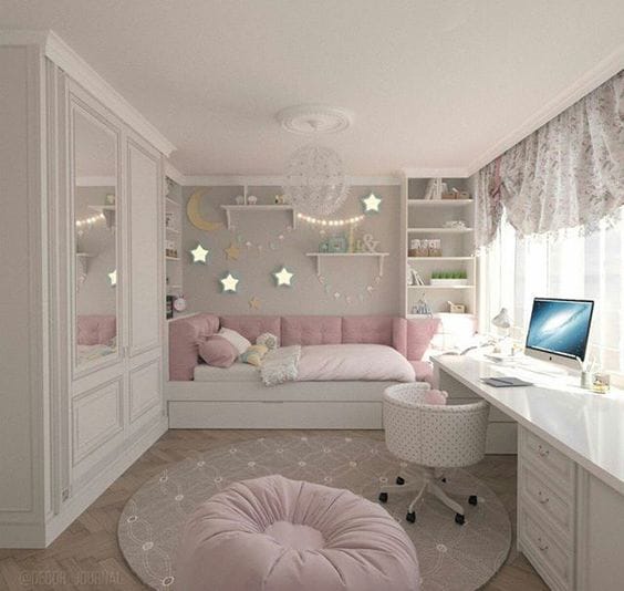 A soft and cozy bedroom with a built-in bed nook, surrounded by shelves and soft lighting.