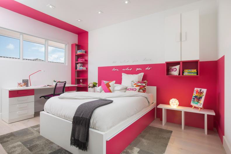 Teen bedroom with bold pink accents, white furniture, and vibrant decor.