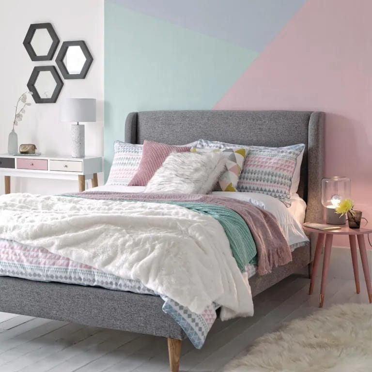 A pastel-themed space with a geometric accent wall and soft textures.