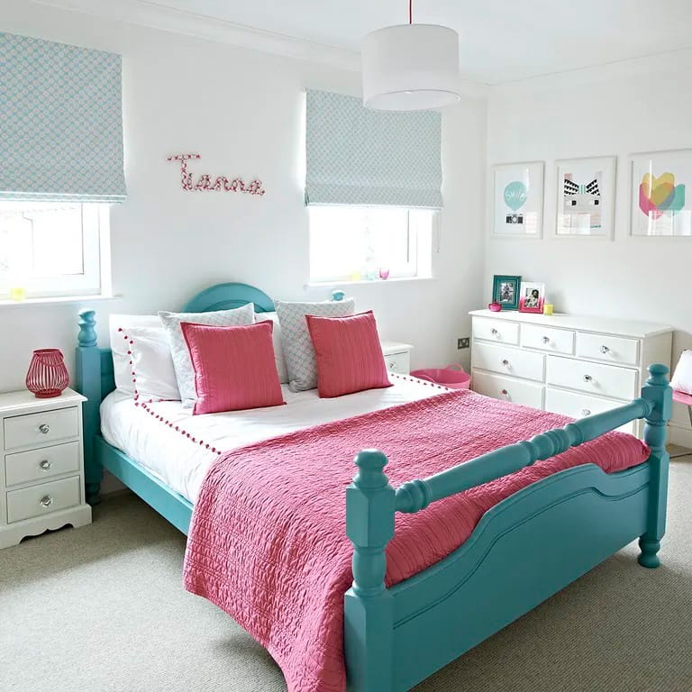 A space featuring a colorful bed frame with pink and blue accents.