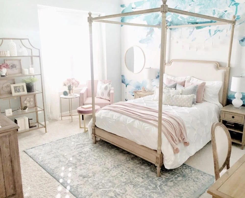 A bedroom with a four-poster bed, pastel decor, and a delicate canopy, creating a vintage and elegant atmosphere.