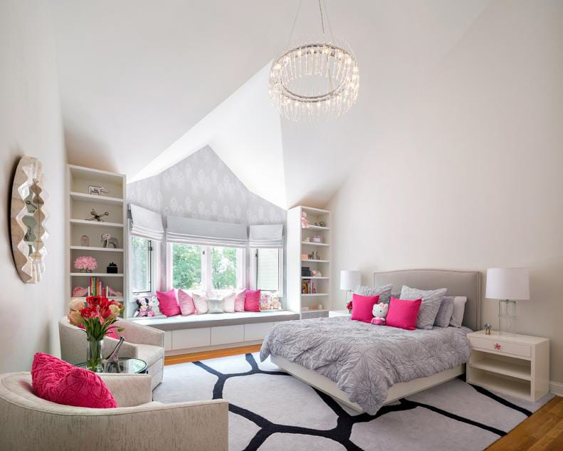 Elegant teen bedroom with soft pink accents, plush furnishings, and a chandelier.