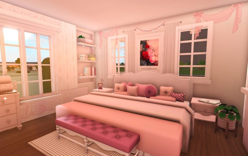 A romantic bedroom with pink and white decor, a cozy bed with plush pillows, and delicate wall art.