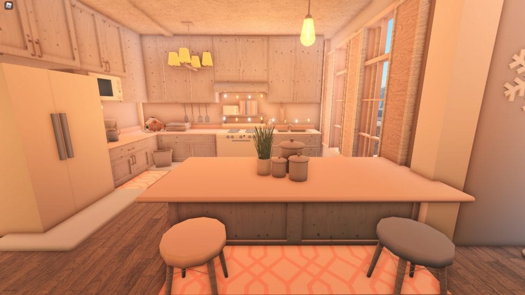 A cozy Bloxburg kitchen with light wood cabinetry, soft lighting, and blush winter decor.