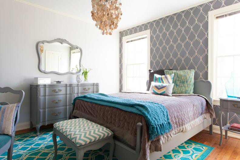 Classic teen bedroom with a muted color palette, chandelier, and patterned accents.