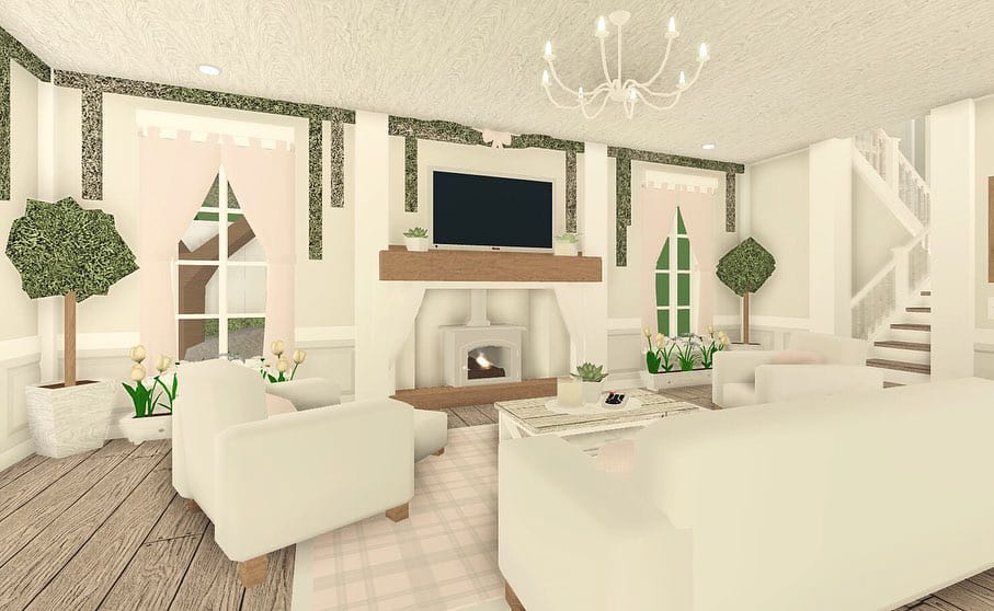 Soft pink Bloxburg living room with pastel accents, floral decor, and a cozy fireplace.