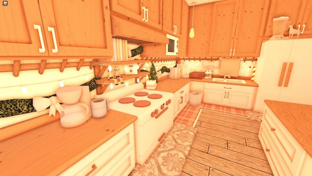 A cozy Bloxburg kitchen with warm wood cabinetry, holiday decorations, and soft lighting for Christmas.