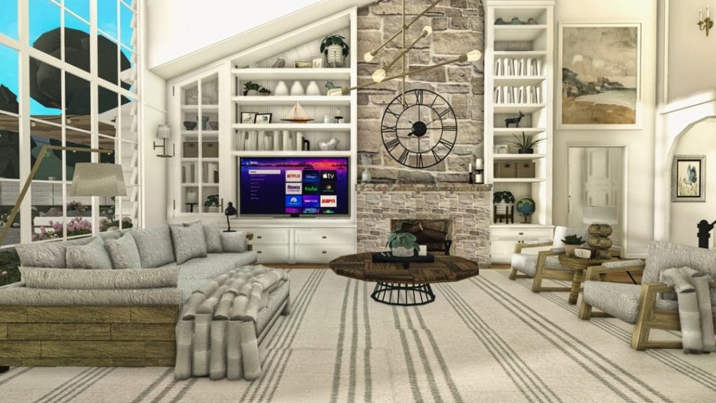 Coastal living room with large windows, stone fireplace, and built-in shelves.