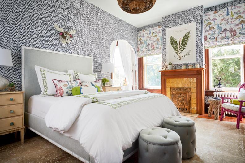 Eclectic teen bedroom with bold wallpaper, playful textiles, and unique decor.