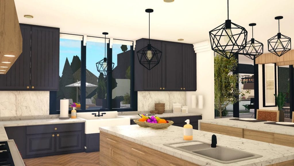 Modern kitchen with dark cabinetry, marble countertops, and geometric pendant lights.