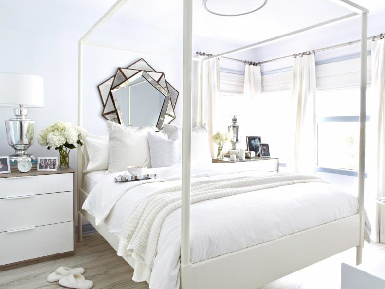 Elegant teen bedroom with all-white decor, four-poster bed, and mirrored accents.