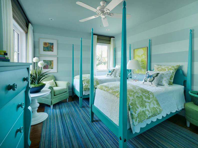 Coastal-themed teen bedroom with aqua and green decor, twin beds, and striped walls.