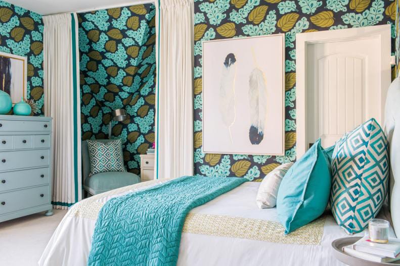 Teen bedroom with teal and green leaf-patterned wallpaper and tropical decor.