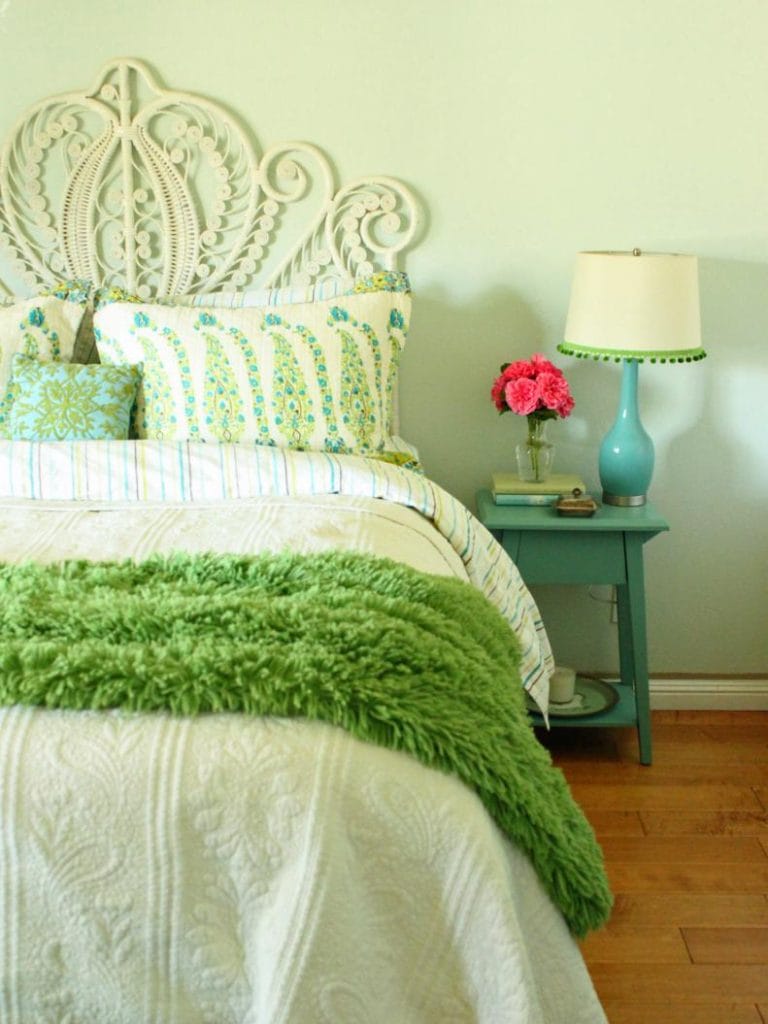 Fresh teen bedroom with pastel colors, playful patterns, and an intricate headboard.